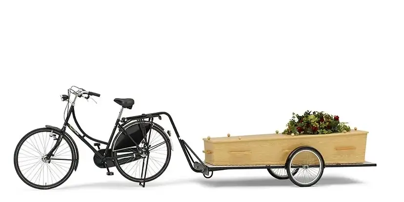 Rouwfiets met aanhanger voor kist als duurzaam uitvaartvervoer